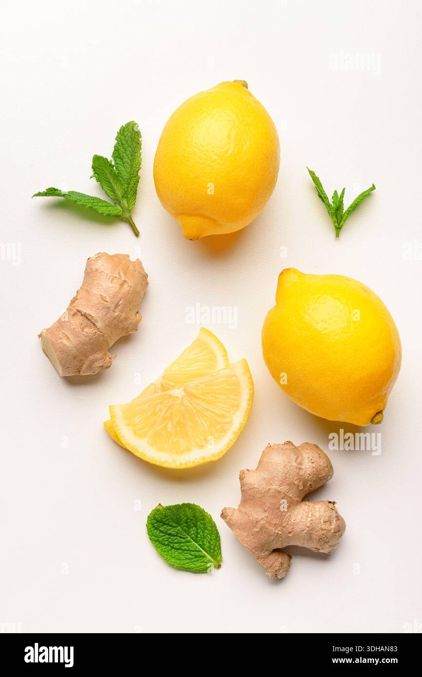 Fresh lemons with mint and ginger on white background Stock Photo