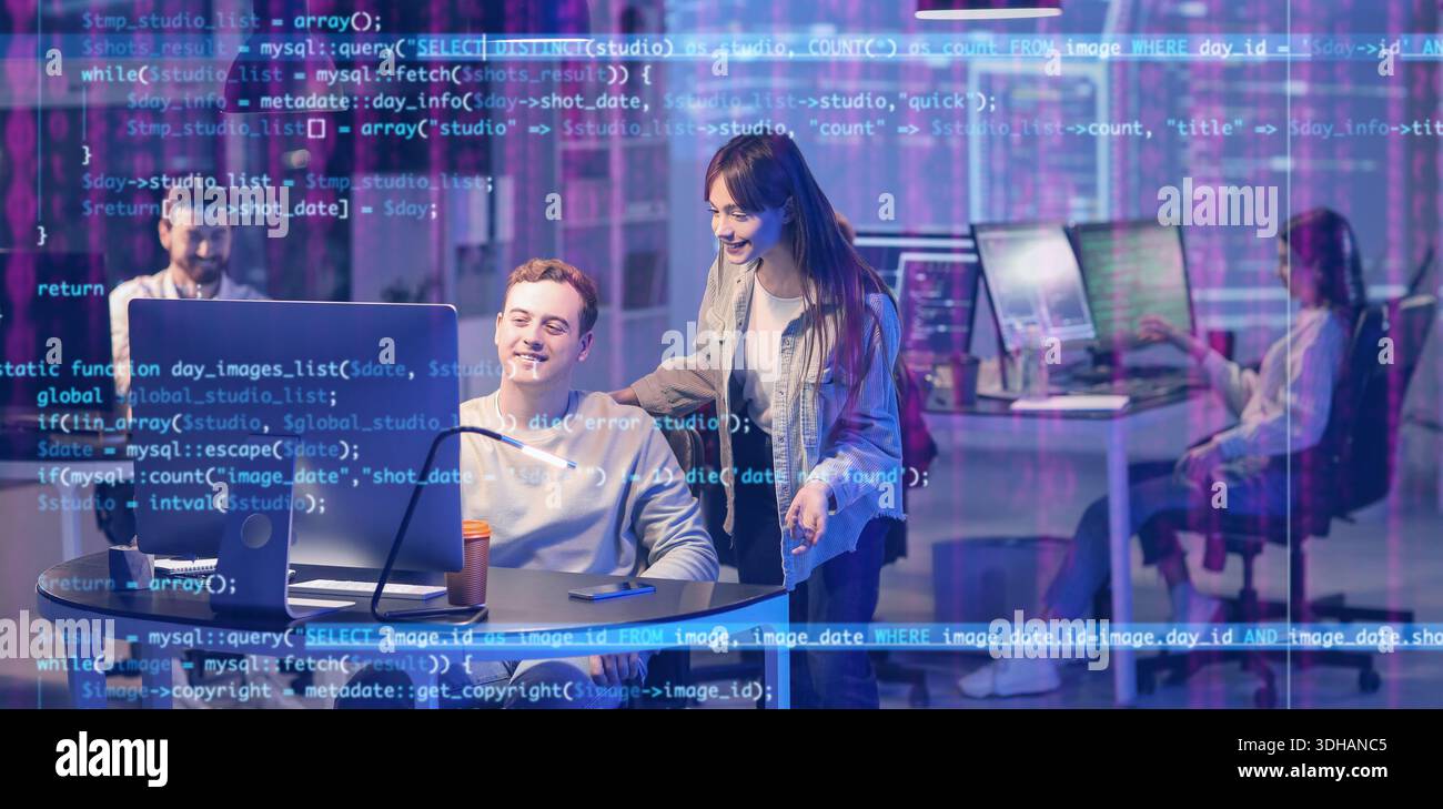 Team of programmers working in office at night Stock Photo