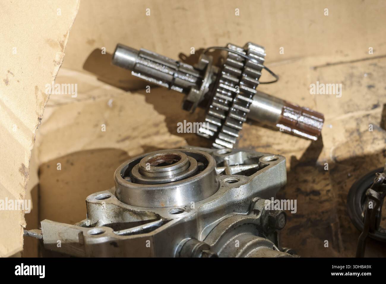 Used metallic gear and steel shaft component repair parts placed on ...