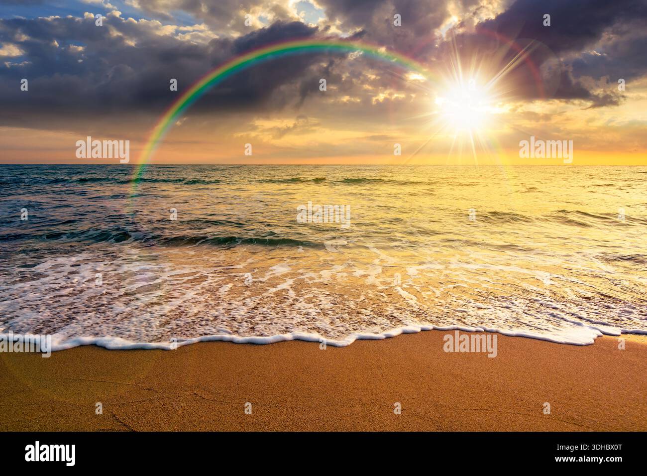 sand beach at the sea for summer vacation concept. beautiful sunset at perfect coast with calm waves and clouds on sky in evening light. scenic landsc Stock Photo