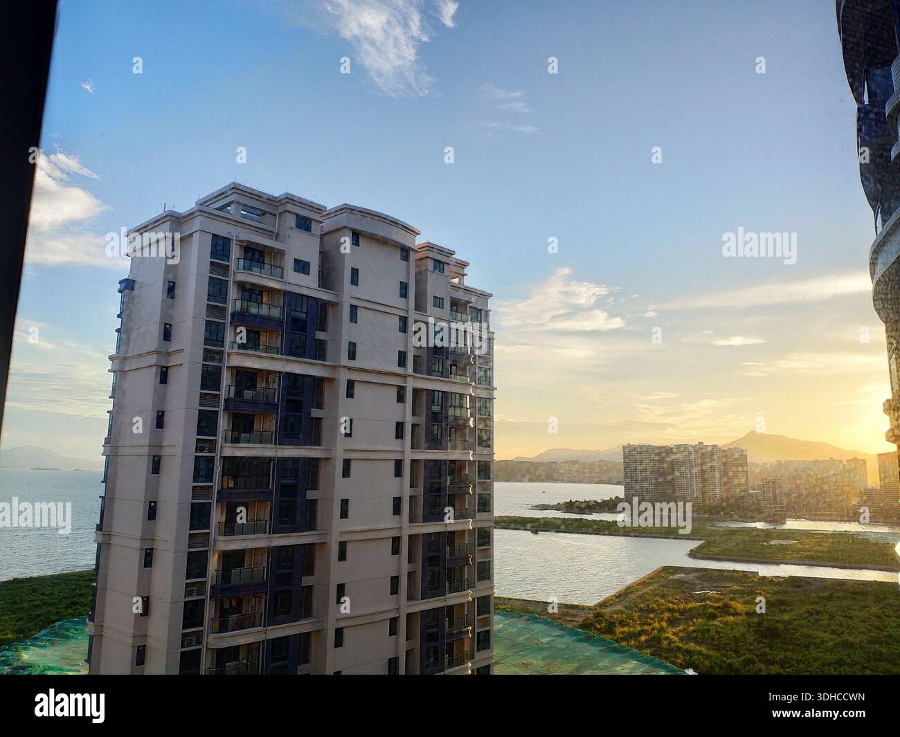Modern High-Rise Apartment Building Overlooking Coastal Sunset Stock ...