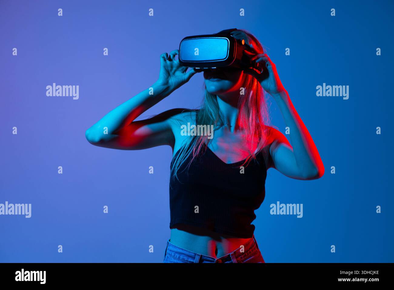 Woman interacting with virtual reality interface using hand gestures, metaverse and immersive technology concept Stock Photo