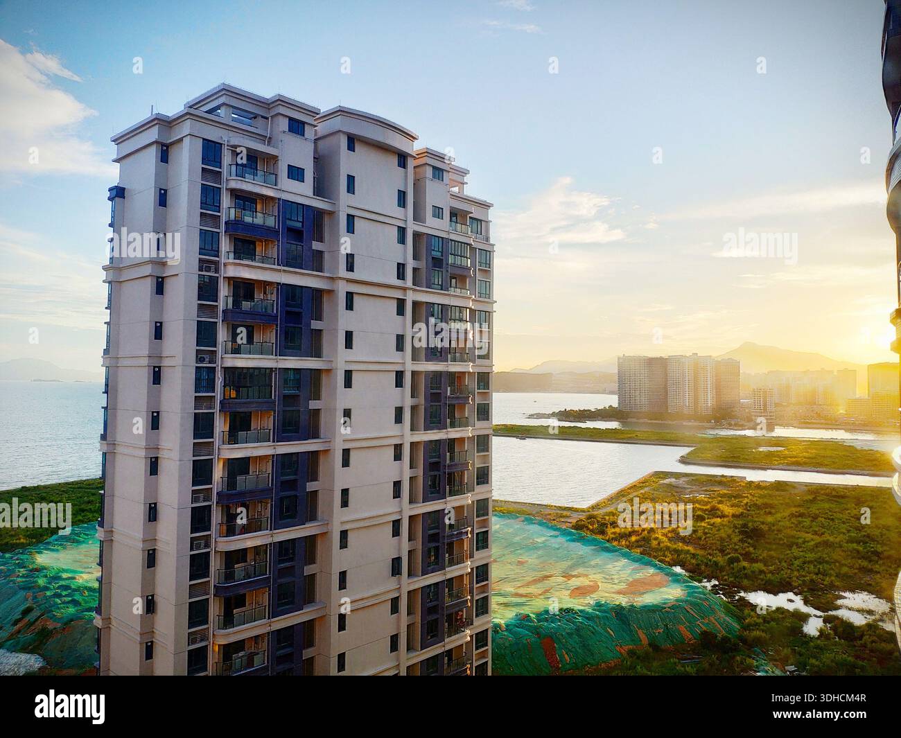 Fresh Look at Modern High Rise Apartment Building Overlooking Coastal Landscape At