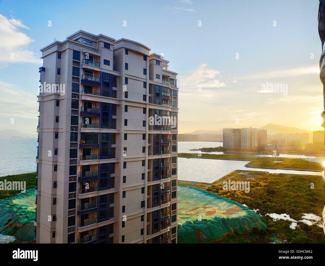 Modern High-Rise Apartment Building at Sunset with Coastal View Stock ...