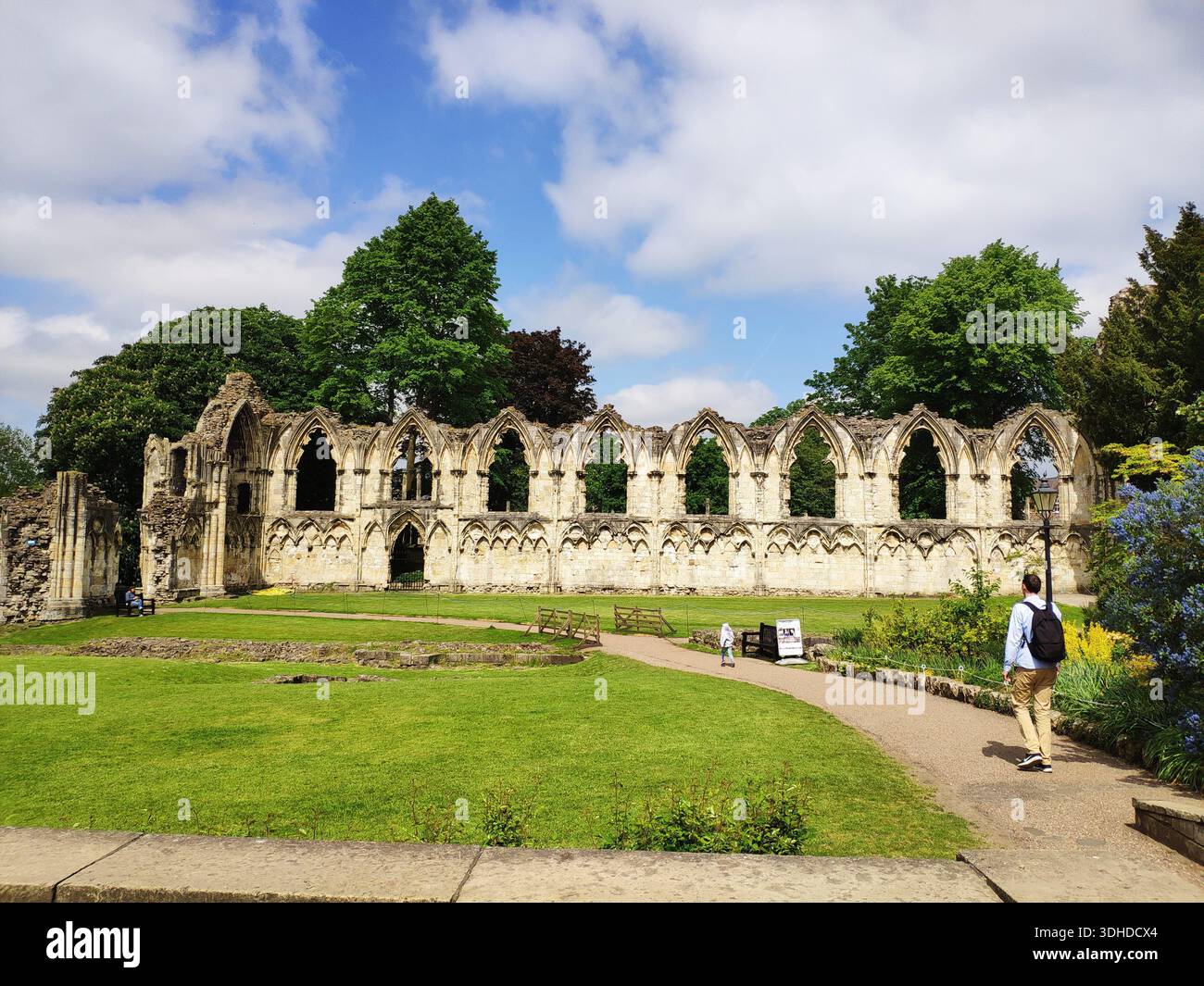 Stone Priory Ruins of a historic abbey with arched stone walls under a blue sky ...