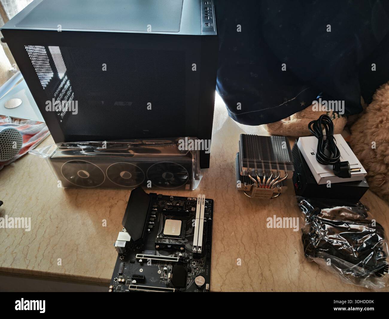 Components for building a custom PC on a workbench Stock Photo