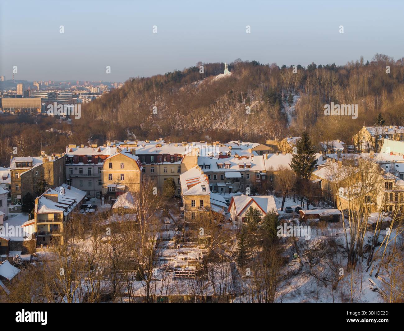 Aerial view of snow-dusted rooftops and tree-lined streets leading to ...
