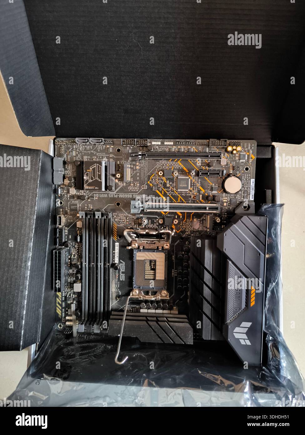 New motherboard with CPU socket and cooling shroud inside packaging box Stock Photo