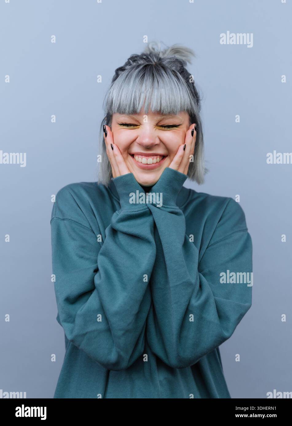 Smiling woman wearing teal hi-res stock photography and images - Alamy
