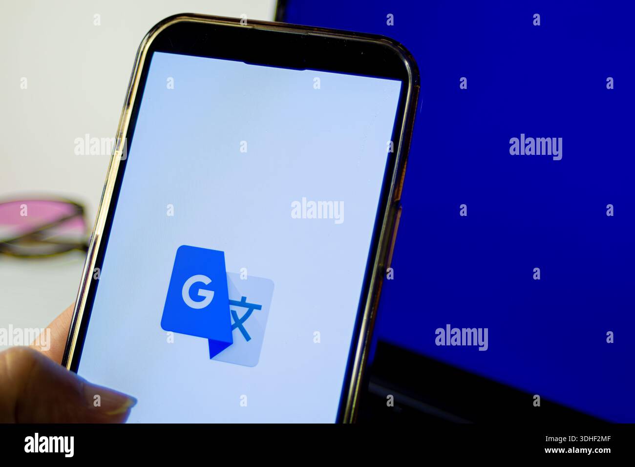 Smartphone screen showing google translate app icon, symbolizing ...