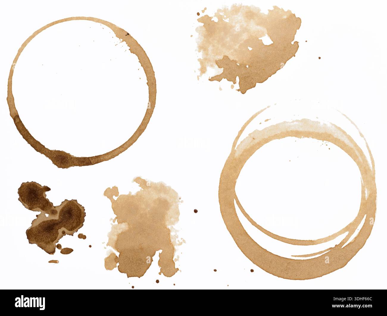 Various coffee stains, cup circles and shapeless spots with different color intensities, small splashes, isolated on white background. Stock Photo