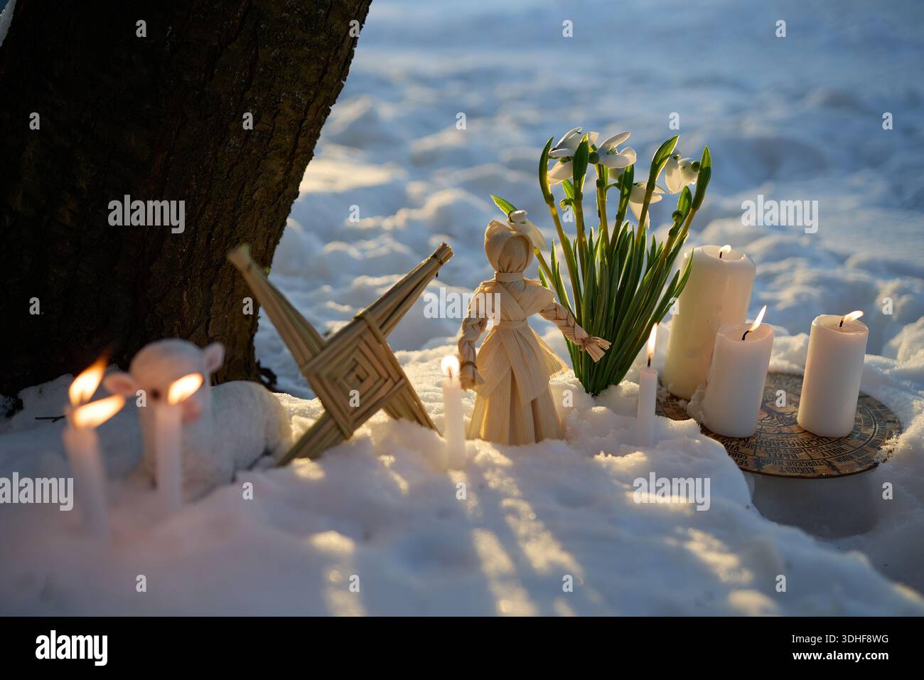Snowfall Rituals Imbolc pagan ritual with brigid's cross in snow Stock Photo - Alamy