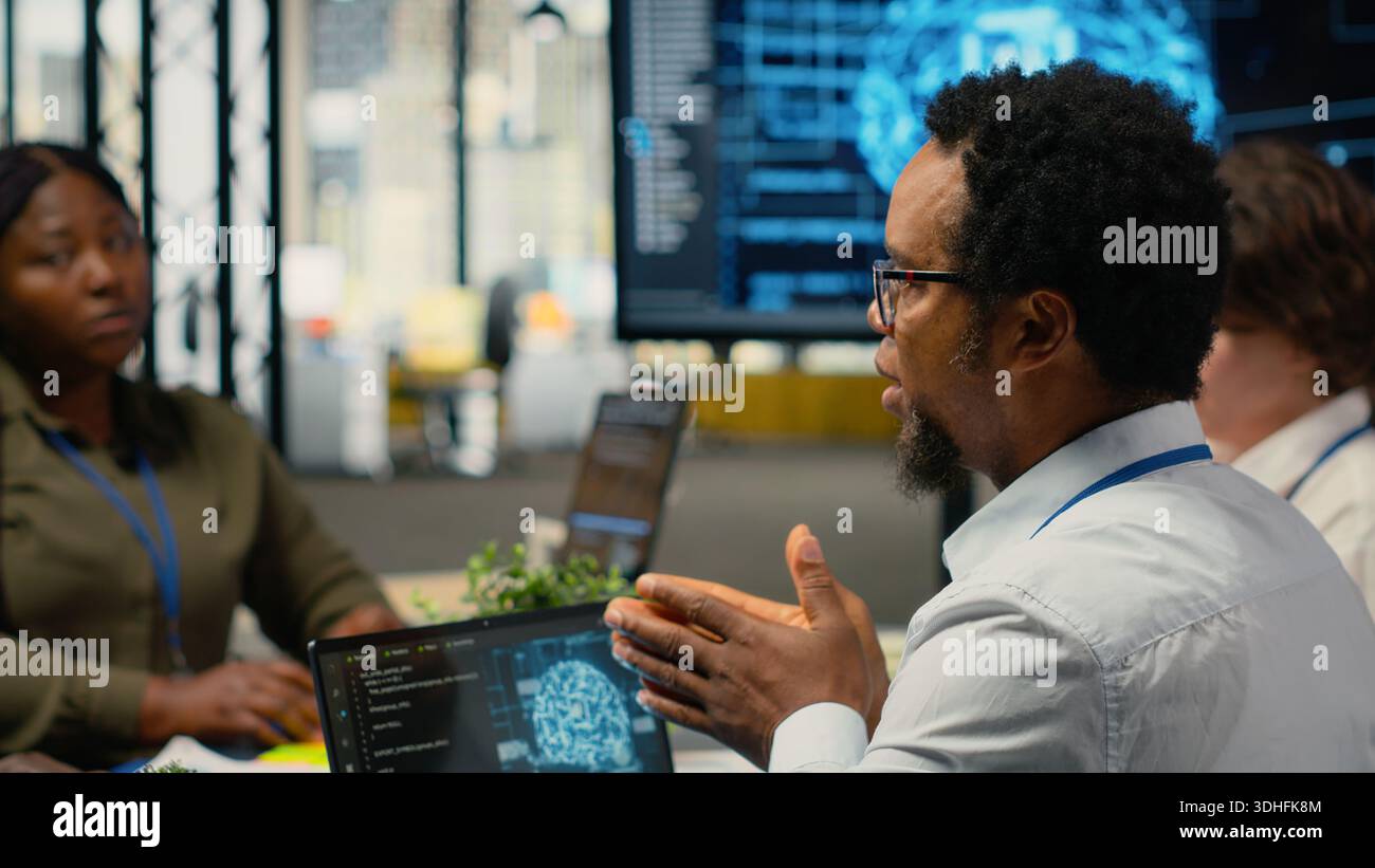 System administrators working in AI startup training predictive models for language processing tasks. Machine learning tech experts use technical expertise for complex IT requirements, camera B Stock Photo