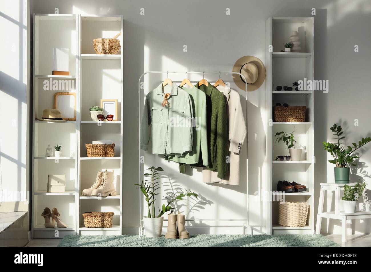 Interior of dressing room with clothes rack and shelf units Stock Photo ...