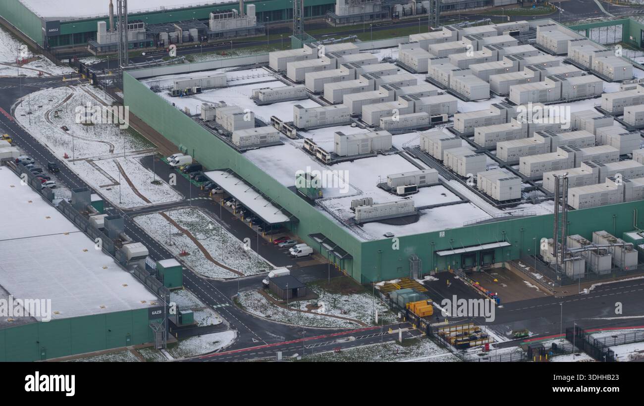 Aerial view of the large, box-like buildings and structures, with light ...