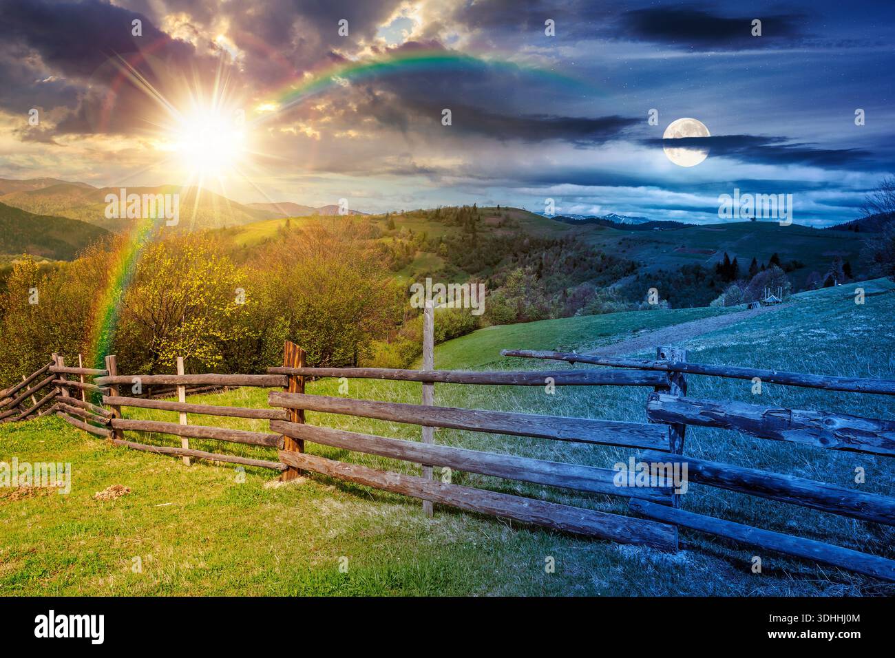 green rural landscape with wooden fence. day and night time change concept. countryside scene with rolling hill in spring with sun and moon at twiligh Stock Photo