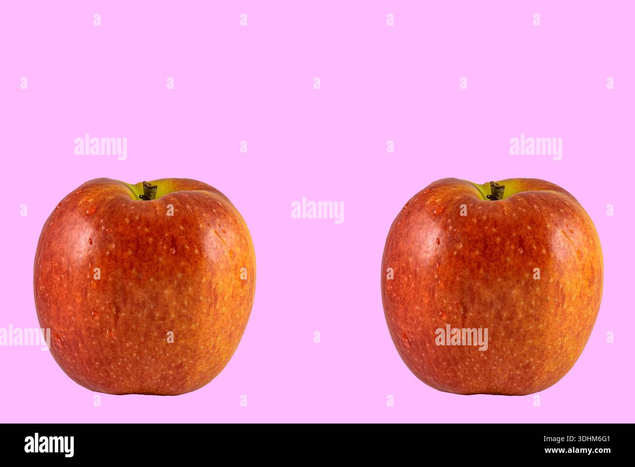 two apples on a pink background Stock Photo