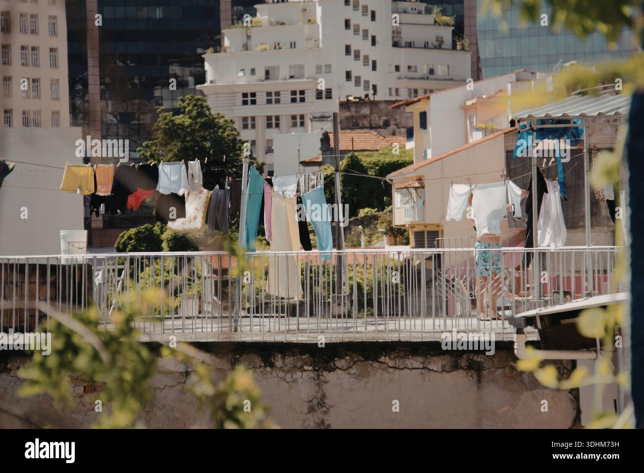 A vibrant urban scene featuring clotheslines strung between buildings ...