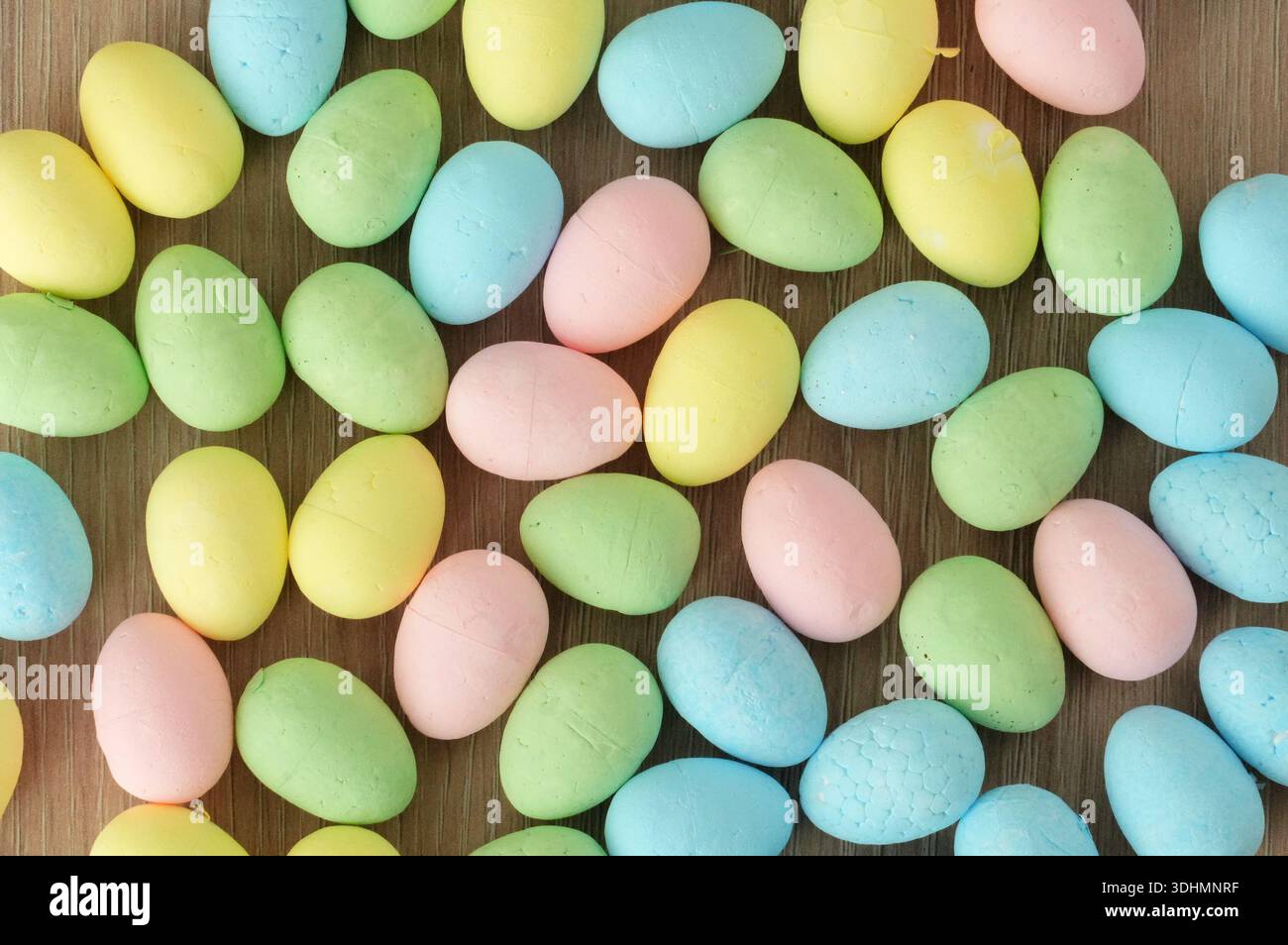 Colorful easter eggs on a wooden background. Top view. Stock Photo