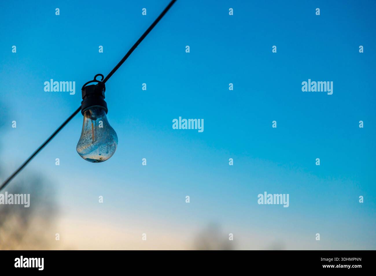 Frozen lightbulb with icicle and snow Stock Photo