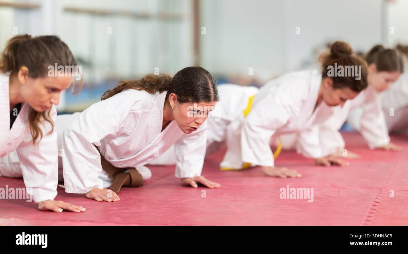 Women doing push-ups in training Stock Photo