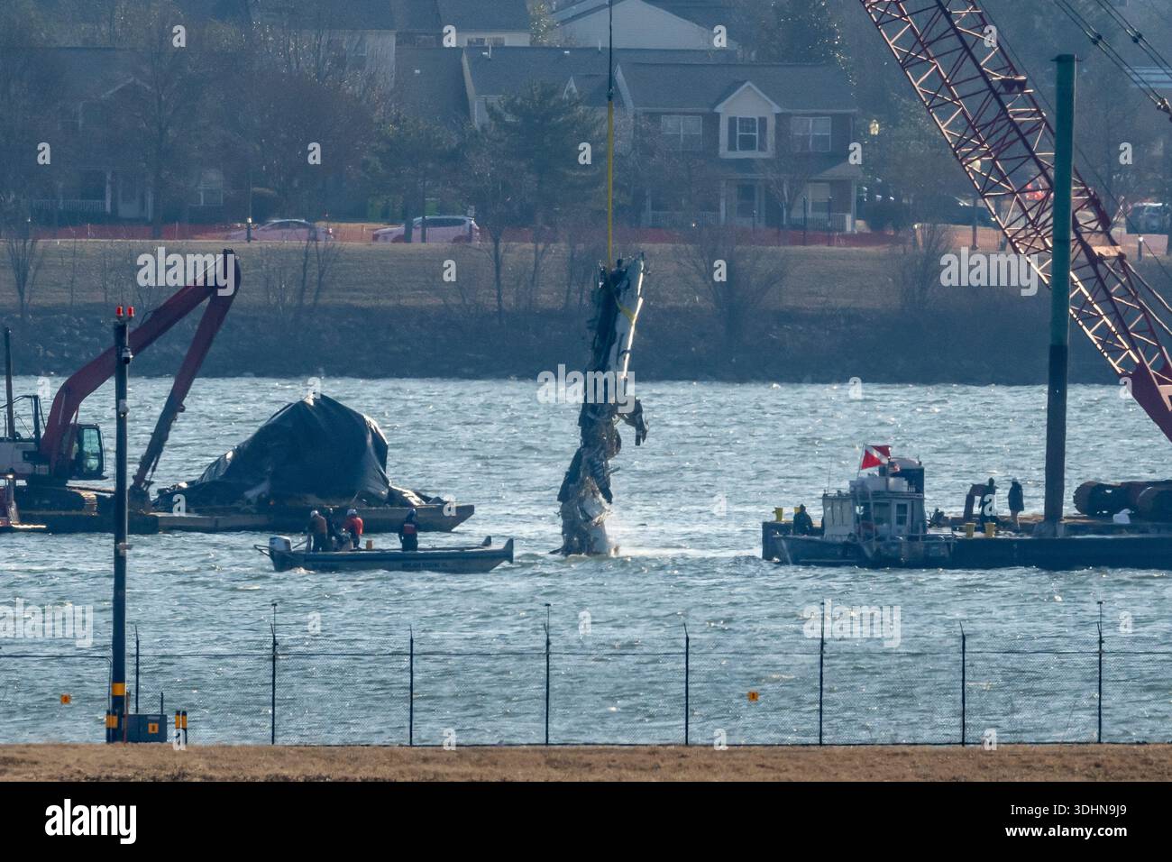 FILE - A piece of wreckage is lifted from the water onto a salvage ...