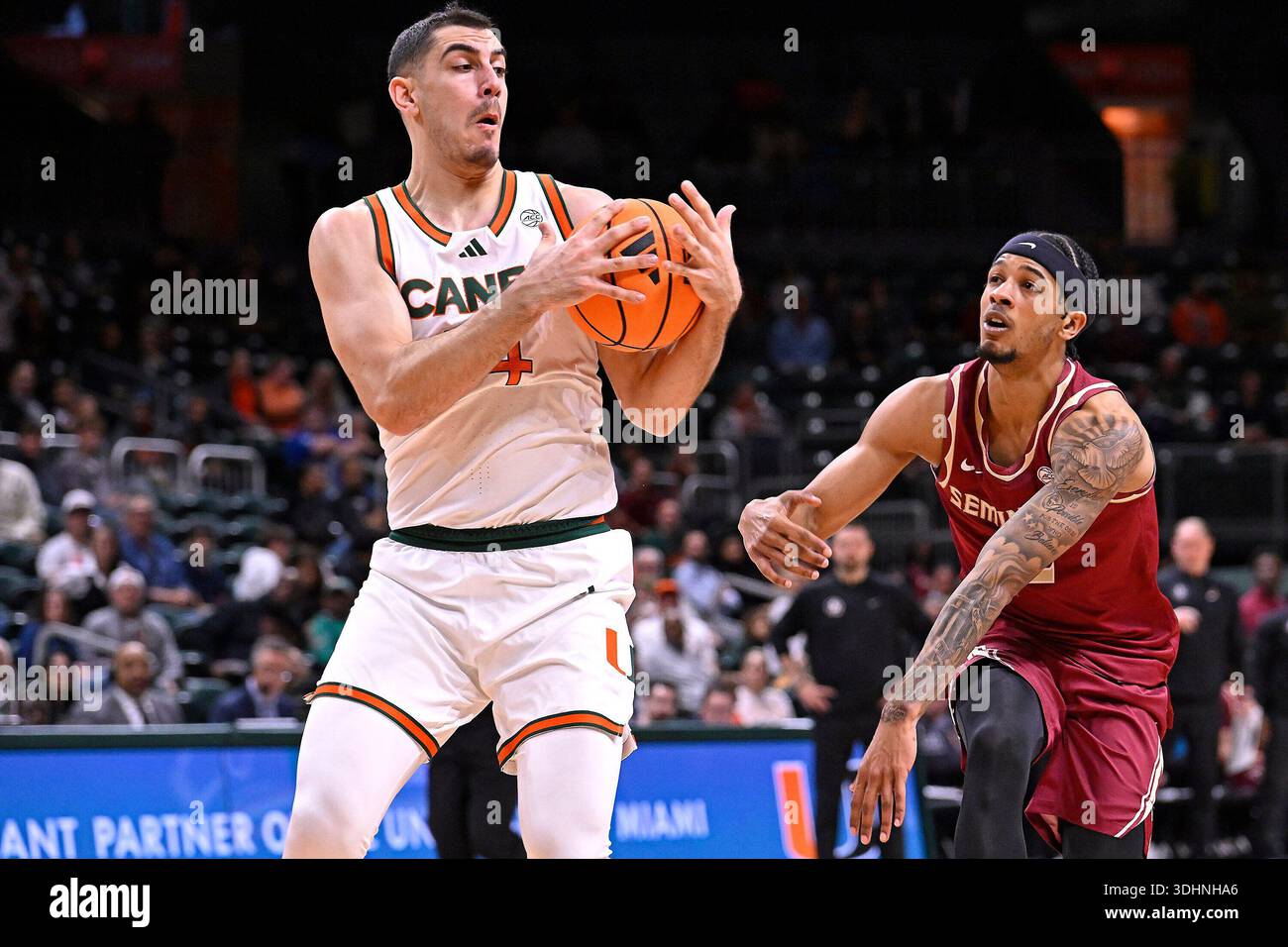 CORAL GABLES, FL - JANUARY 20: Miami guard Noam Dovrat (14) attempts to ...