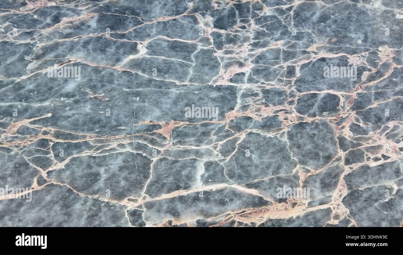 Dark marble surface with light veins and patterns Stock Photo