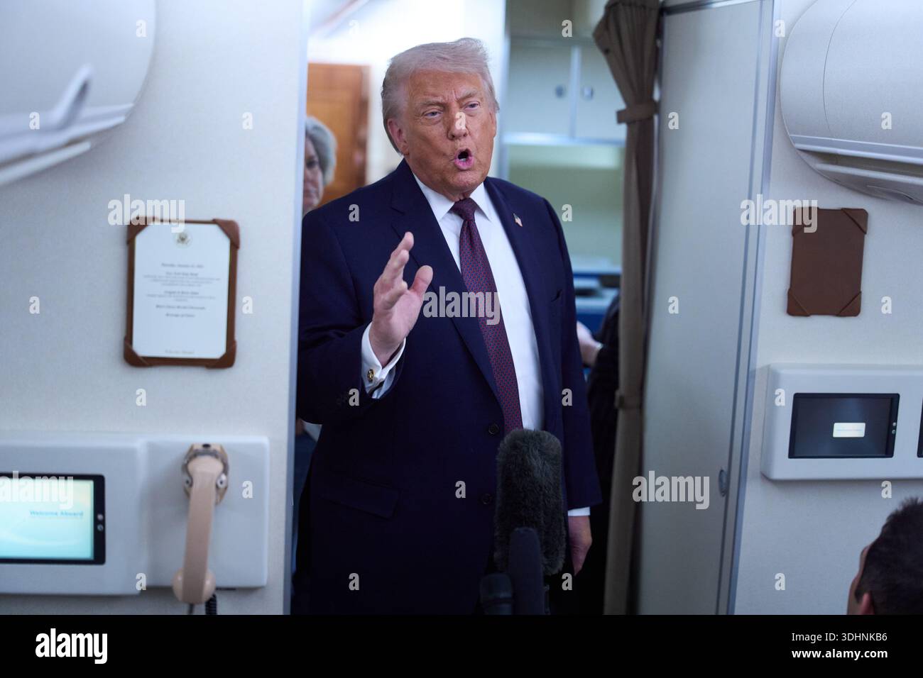 President Donald Trump speaks with reporters aboard Air Force One after ...