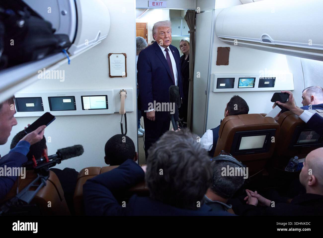 President Donald Trump speaks with reporters aboard Air Force One after ...