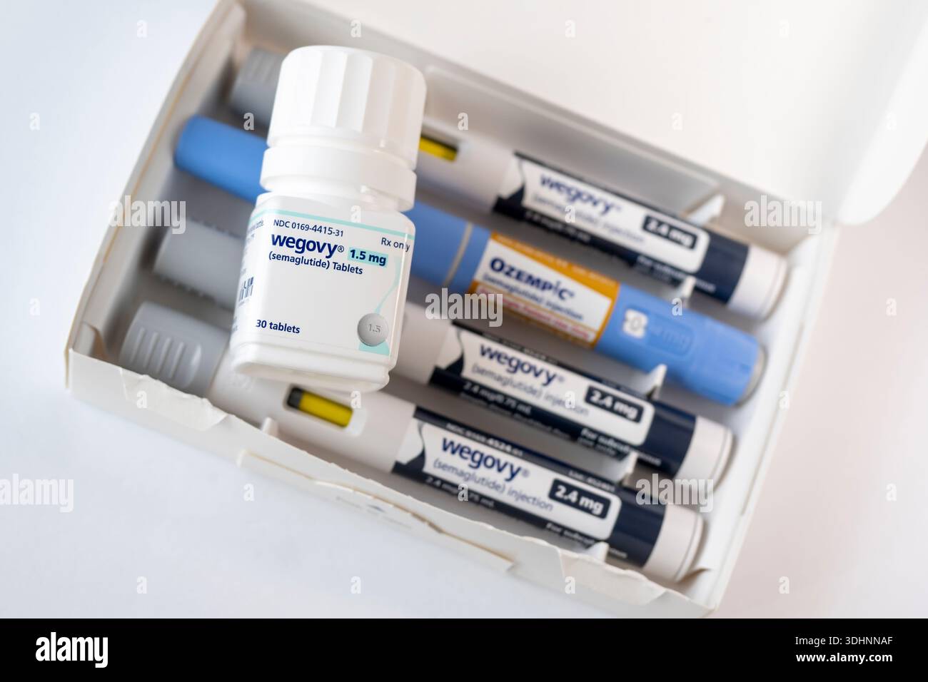 focus semaglutide Photo Illustration of the new Wegovy semaglutide tablets on a white  background with out of focus injection pen. Its a prescription medicine  used with Stock Photo