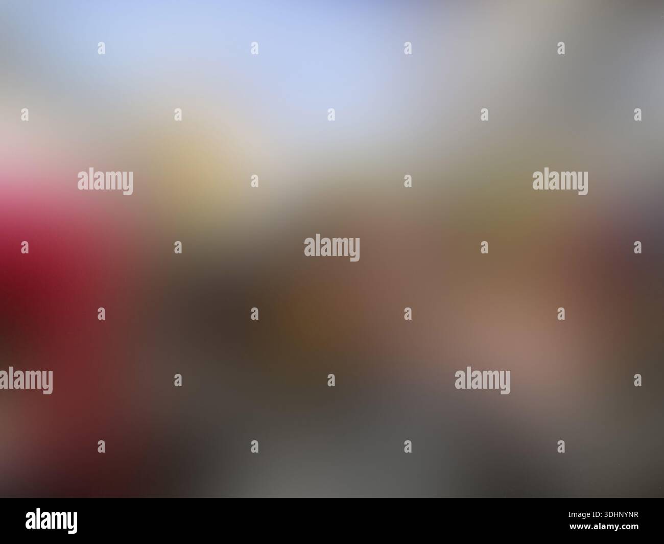 Softly blurred abstract background featuring a palette of blue, yellow, red, and grey, creating a smooth and dreamy bokeh effect for creative designs. Stock Photo