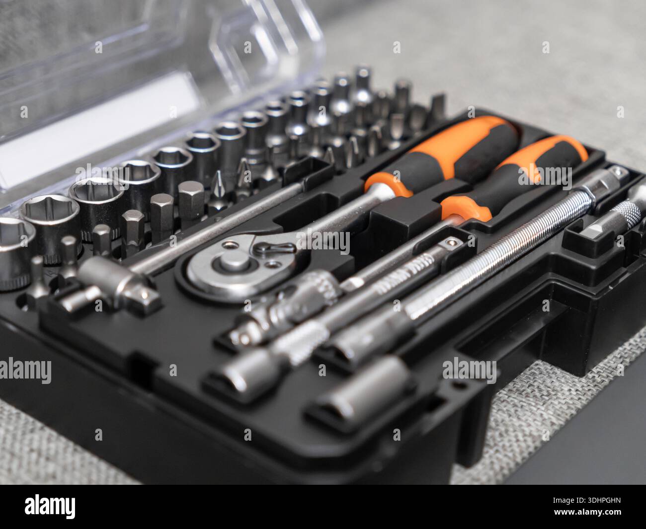 Close-up of a neatly organized black plastic tool case, containing a wide range of metal sockets, bits, and ratchet wrenches for versatile repair appl Stock Photo