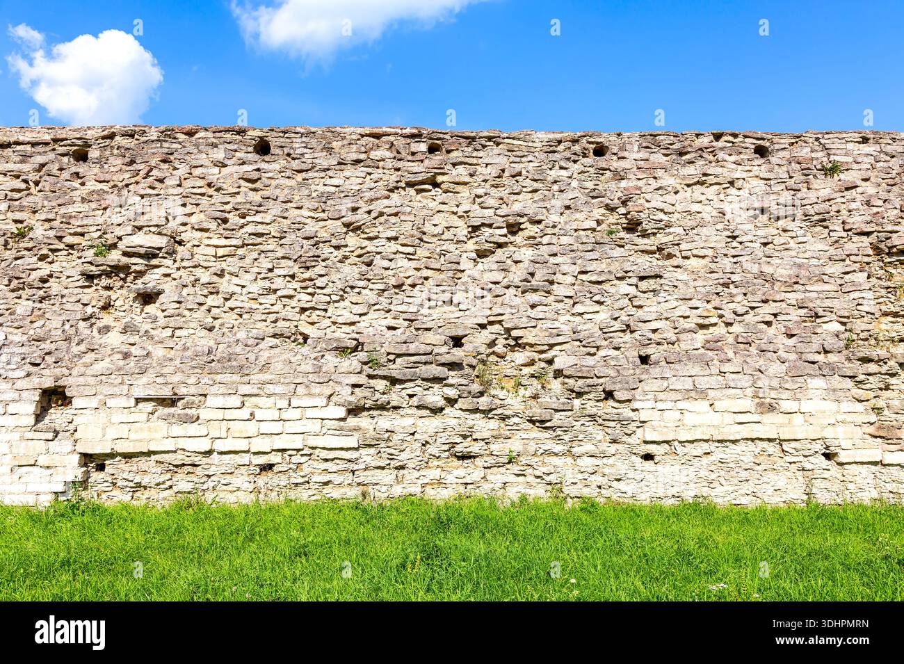 Rough stone wall of the ancient medieval fortress Izborsk in summer Stock Photo