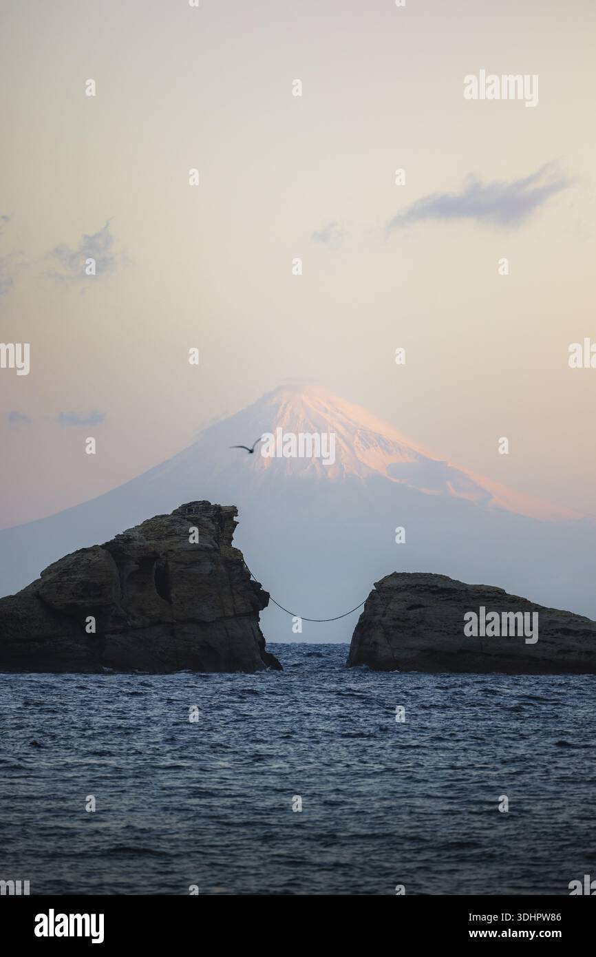 Mount Fuji Rocks View of the jagged rocks meet the sea, a thin rope bridge connecting ...