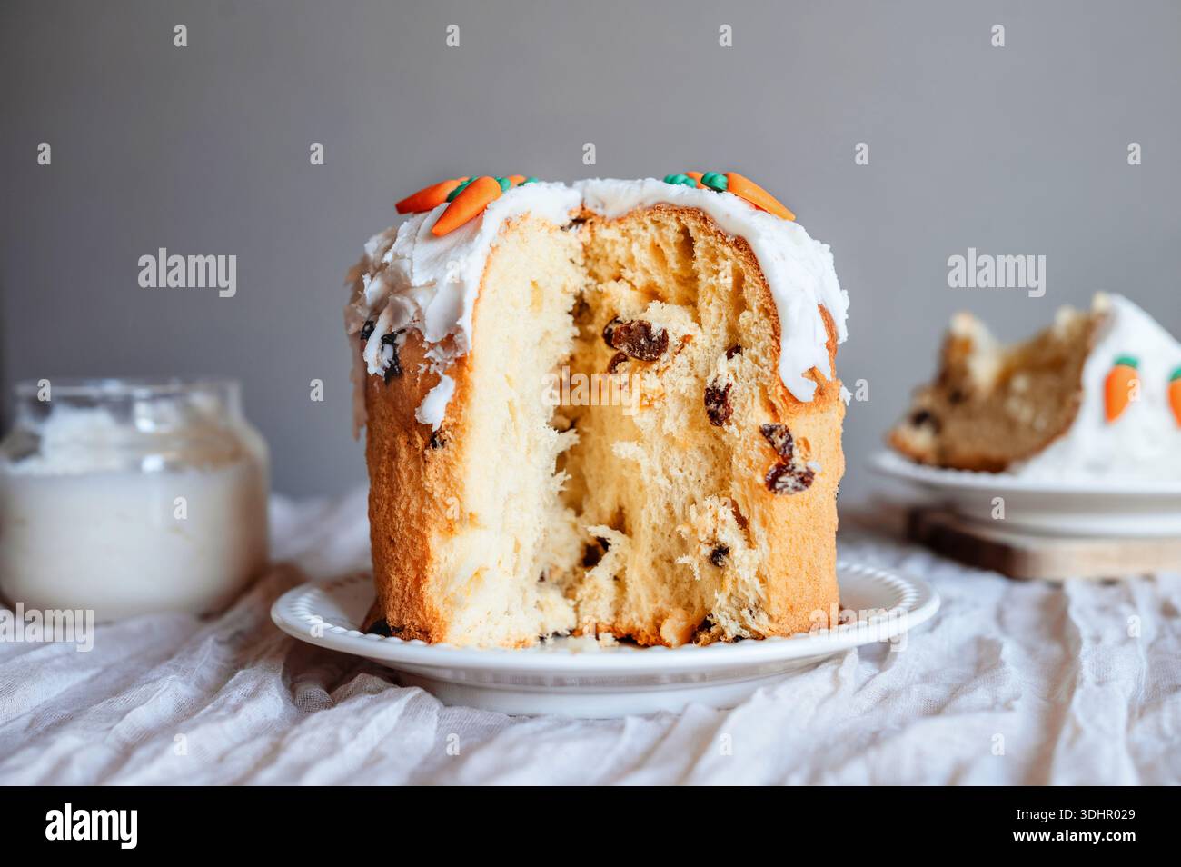 Homemade Easter cake with icing and visible cut section. Stock Photo