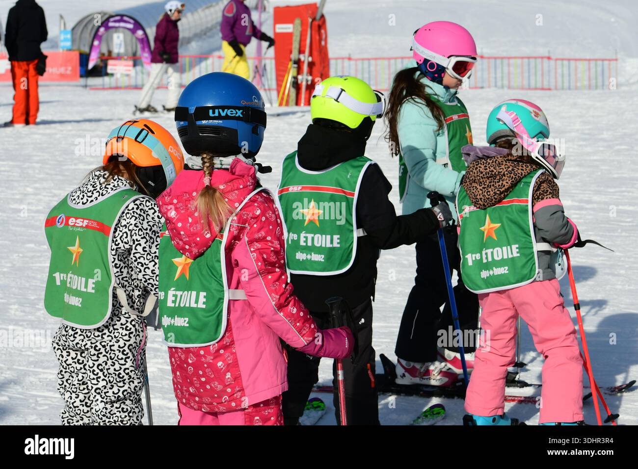 Several children seen in the snow wearing firststar level vests at an