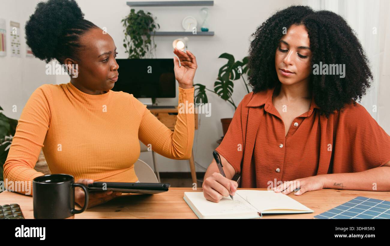 Diverse Startup Team Collaborates At Table During Creative Brainstorm Session In Bright Office Stock Photo