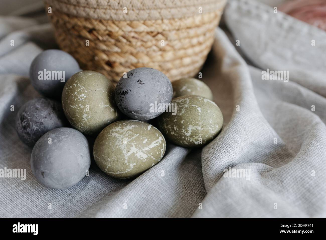 Easter holiday. Painted olive-colored eggs on a linen tablecloth. Easter decoration. Stock Photo
