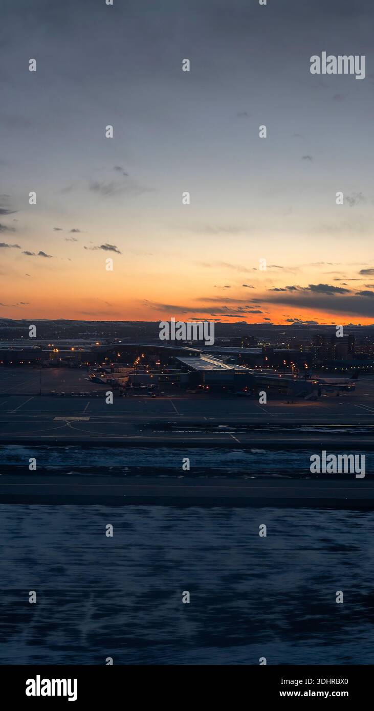 A 9:16 Portrait image of a sunset over Calgary Airport in Alberta, Canada - Stock Image