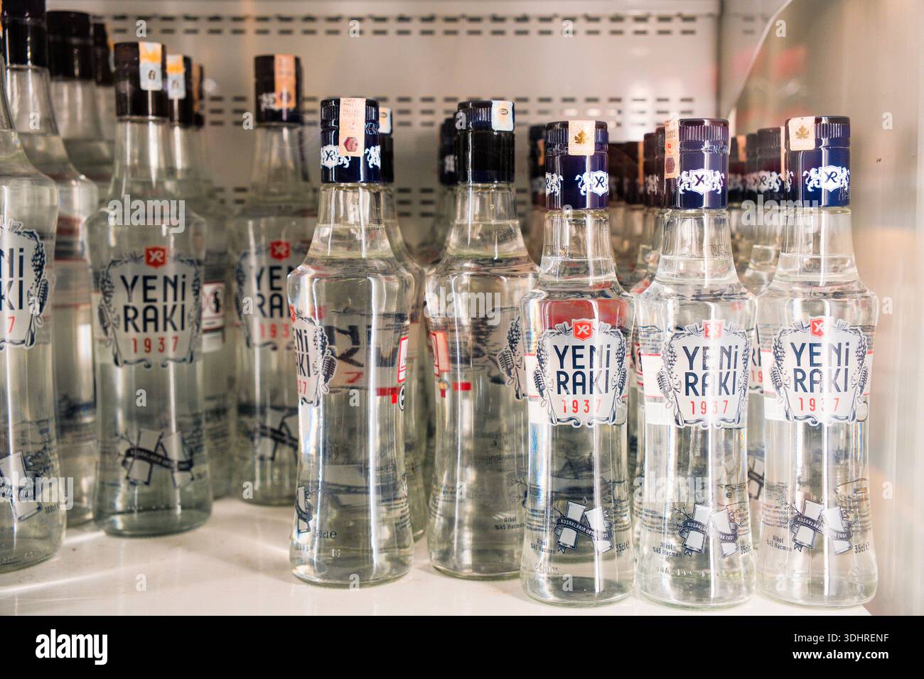 Bottles of Turkish raki are displayed on shelves inside a retail store. Raki is a traditional anise-flavored alcoholic beverage commonly consumed Stock Photo