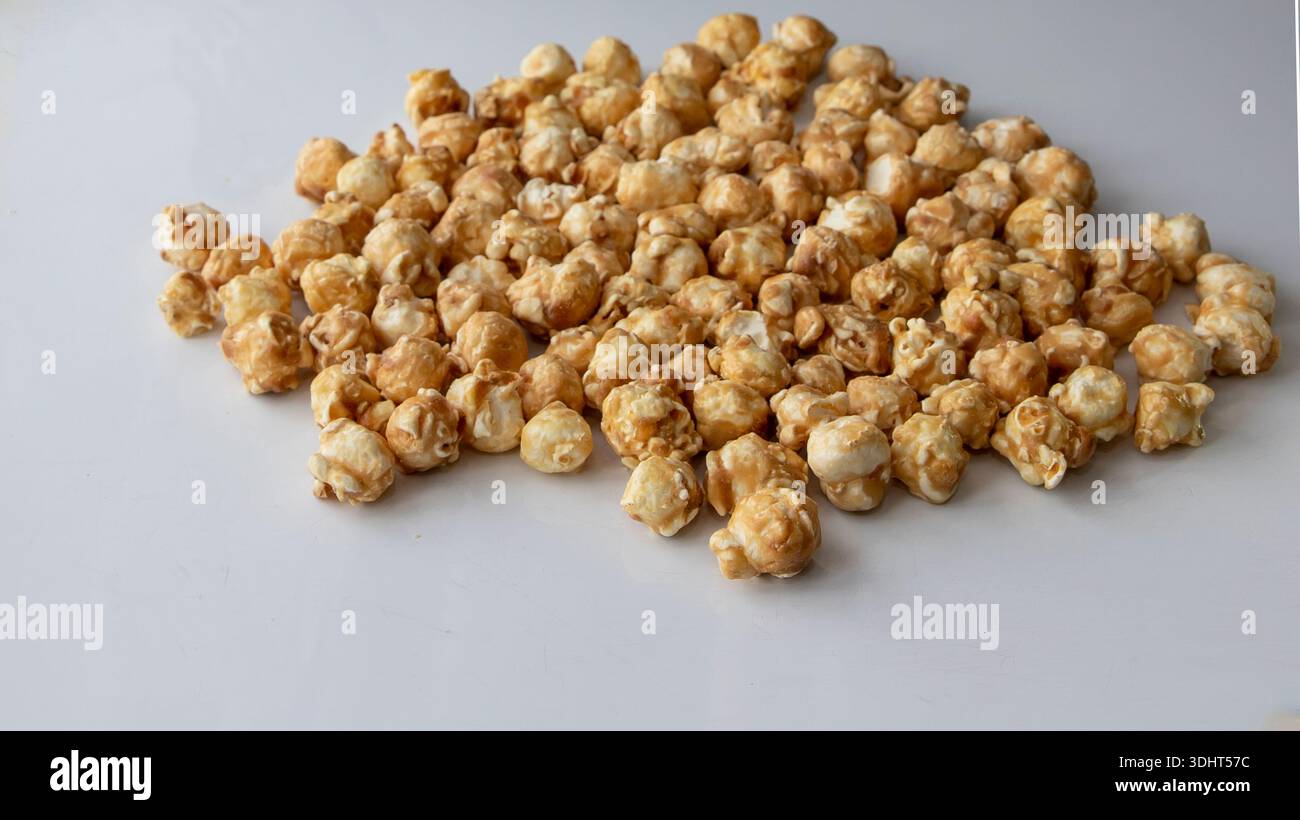 Caramel popcorn scattered on white background close perspective Stock Photo