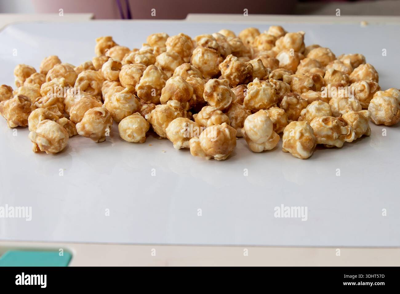 Caramel popcorn scattered on white background close perspective Stock Photo