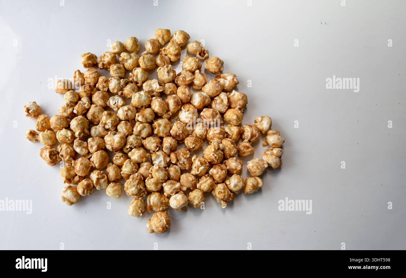Caramel popcorn scattered on white background close perspective Stock Photo