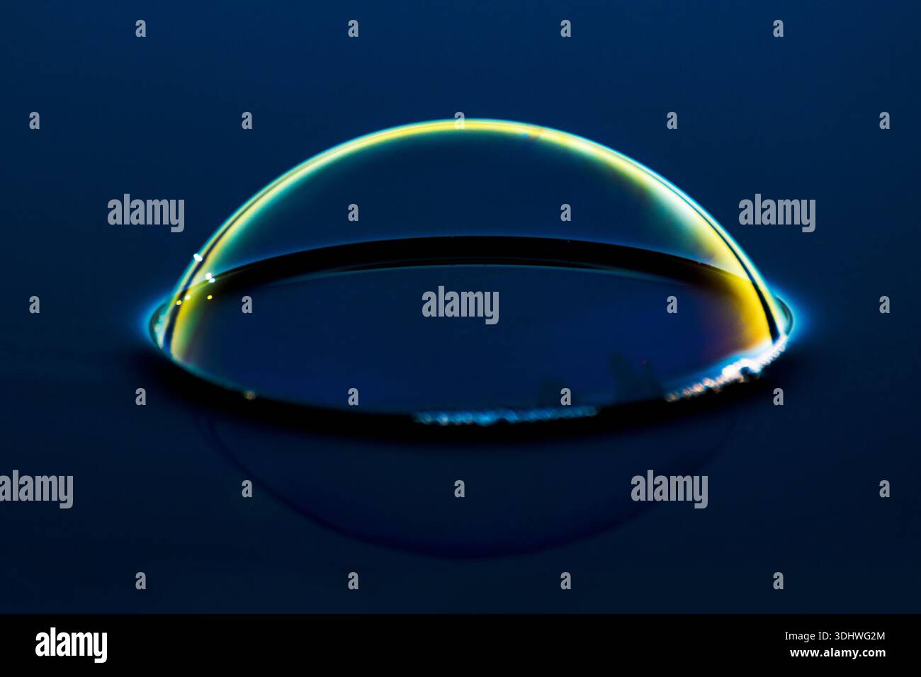 Iridescent Bubble on Dark Water Surface Stock Photo