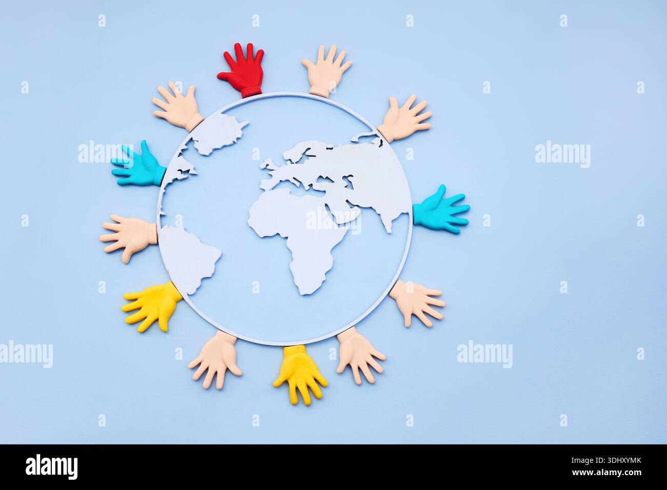 Diverse hands embracing earth globe representing global unity Stock Photo