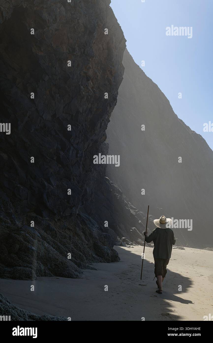 A man walking on the beach at Arch Cape, Oregon. Stock Photo