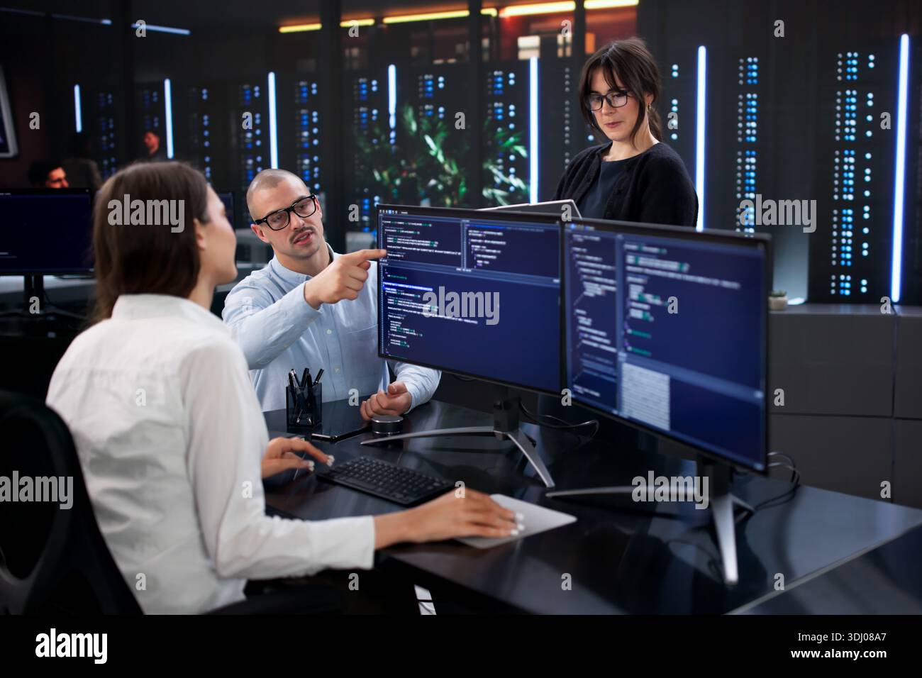 Software Developer Team Analyzing Business Data On Office Computer Screens Stock Photo