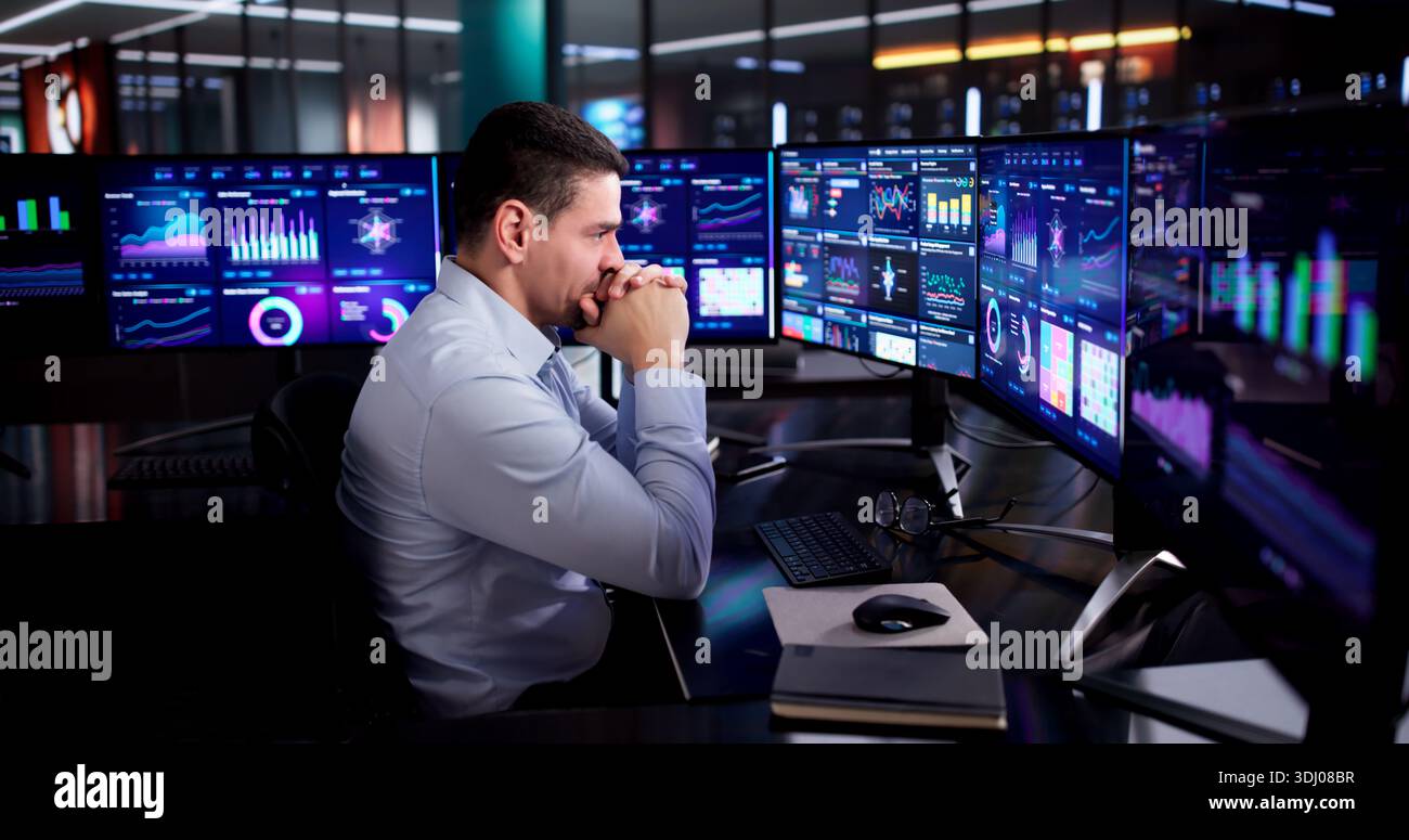 Stressed Accountant Analyzing Budget Data On Office Computer Screen. Stock Photo
