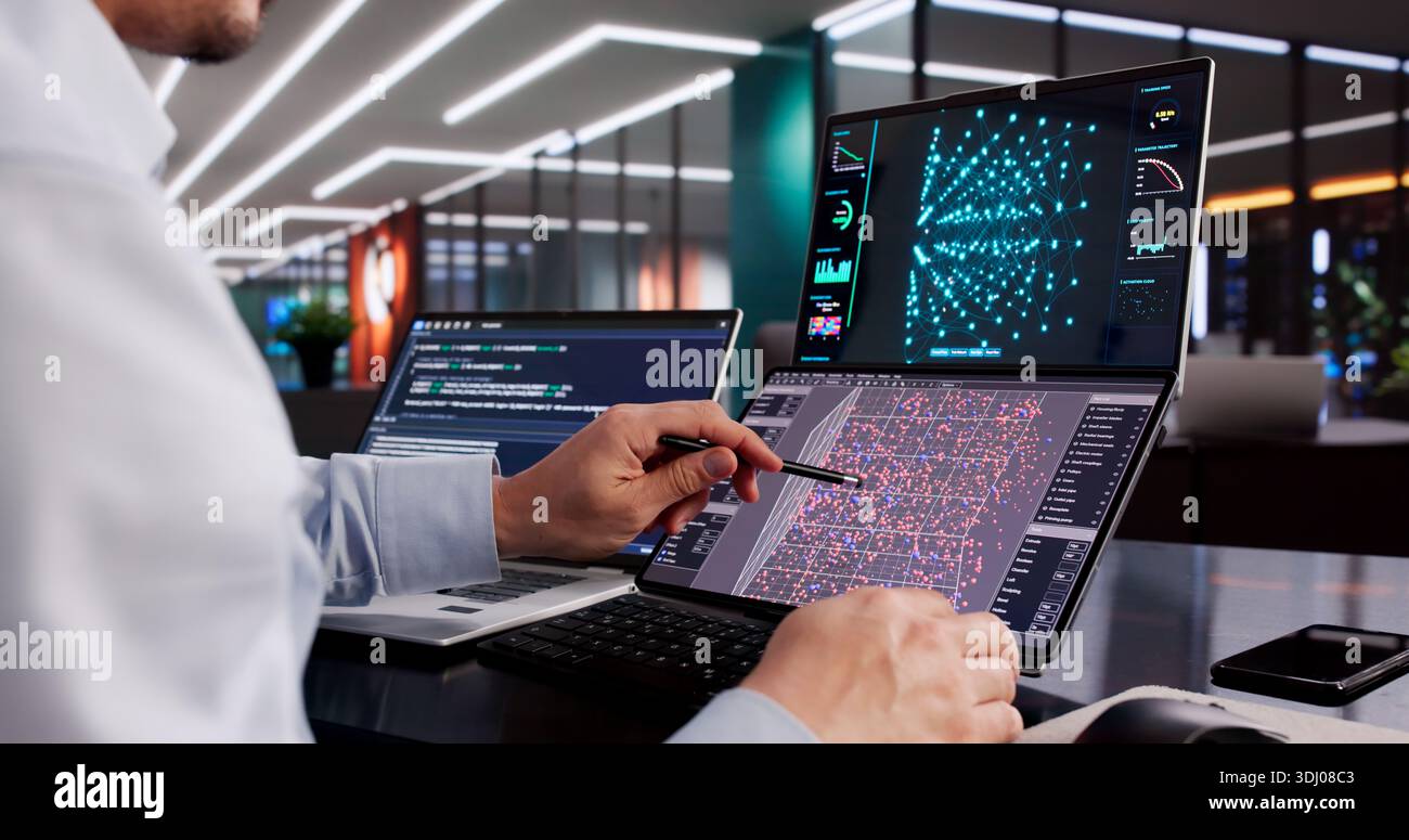Male Engineer Developing AI Technology Using Multiple Computer Screens At Office Stock Photo